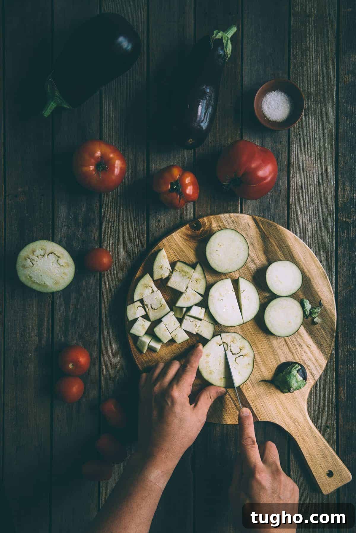 Pasta alla Norma with Eggplant and Ricotta Salata 3 eggplants and tomatoes being cut on a chopping board