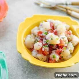 Yellow bowl with scallop ceviche.