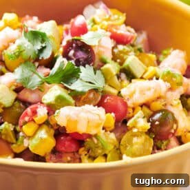 Salad with shrimp and avocado in yellow serving bowl.