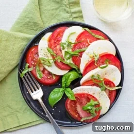 Tomato and Mozzarella Caprese Salad on black plate.