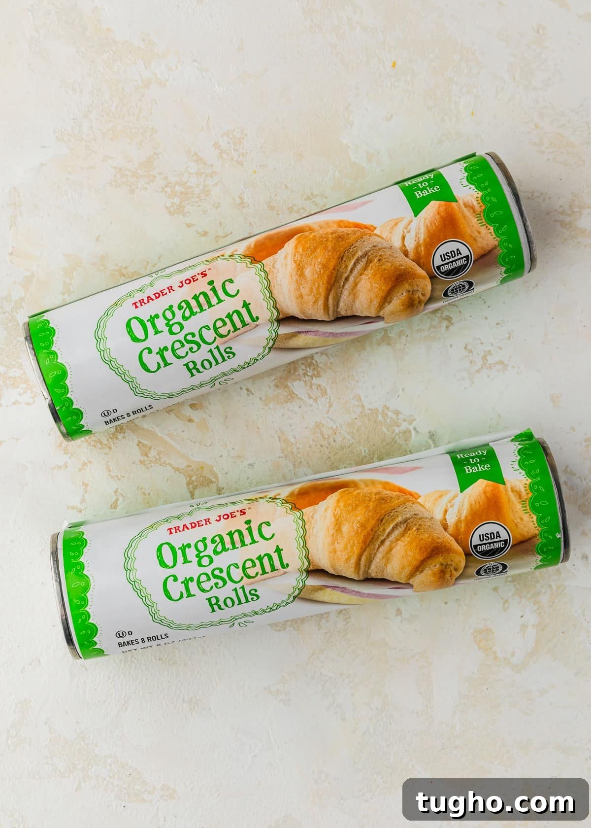 3-Ingredient Air Fryer Pigs in a Blanket Recipe 3 Two rolls of crescent rolls on a beige table.