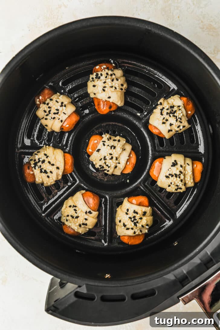 3-Ingredient Air Fryer Pigs in a Blanket Recipe 8 Raw pigs in a blanket in an air fryer.