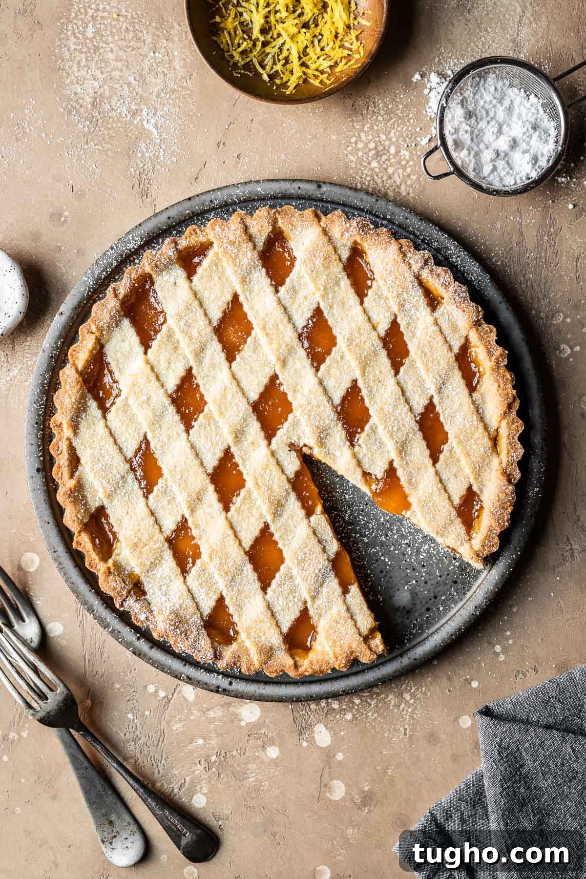 Classic Italian Jam Crostata Recipe 2 A lattice topped crostata di marmellata with one slice removed.