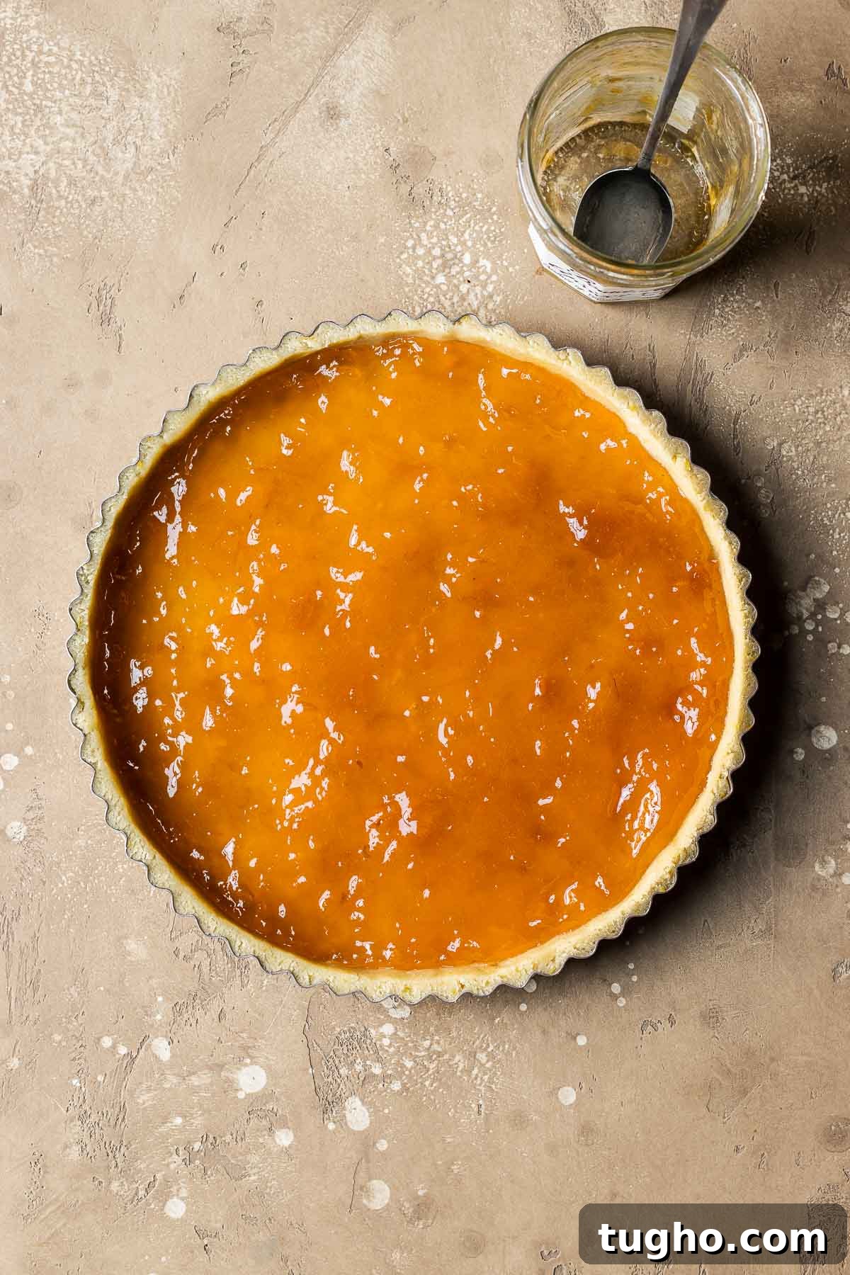 Classic Italian Jam Crostata Recipe 11 An unbaked tart shell filled with apricot jam.