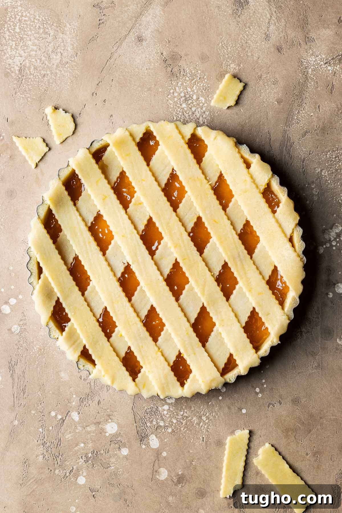 Classic Italian Jam Crostata Recipe 12 An unbaked crostata di marmellata with strips of lattice dough on top.
