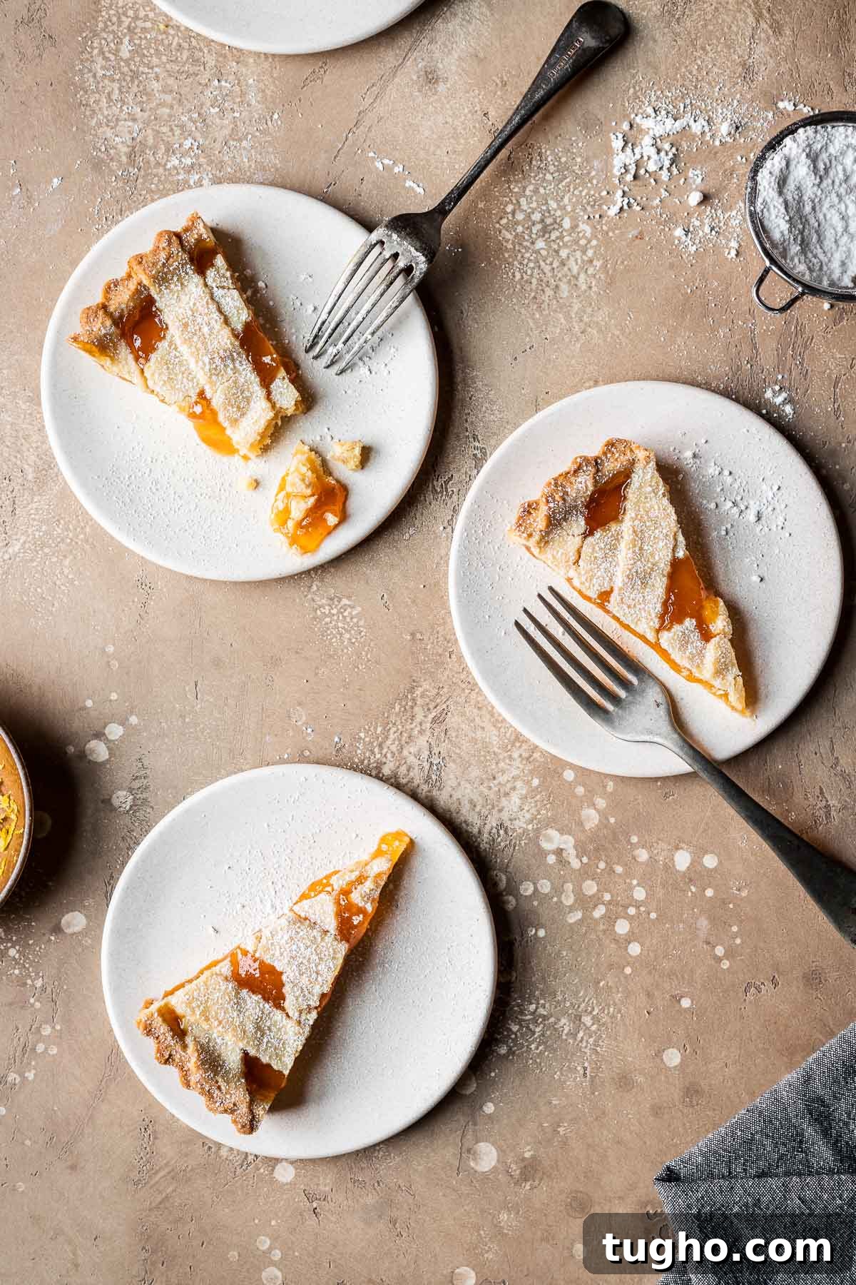 Classic Italian Jam Crostata Recipe 15 Three slices of lattice topped jam tart on tan plates.