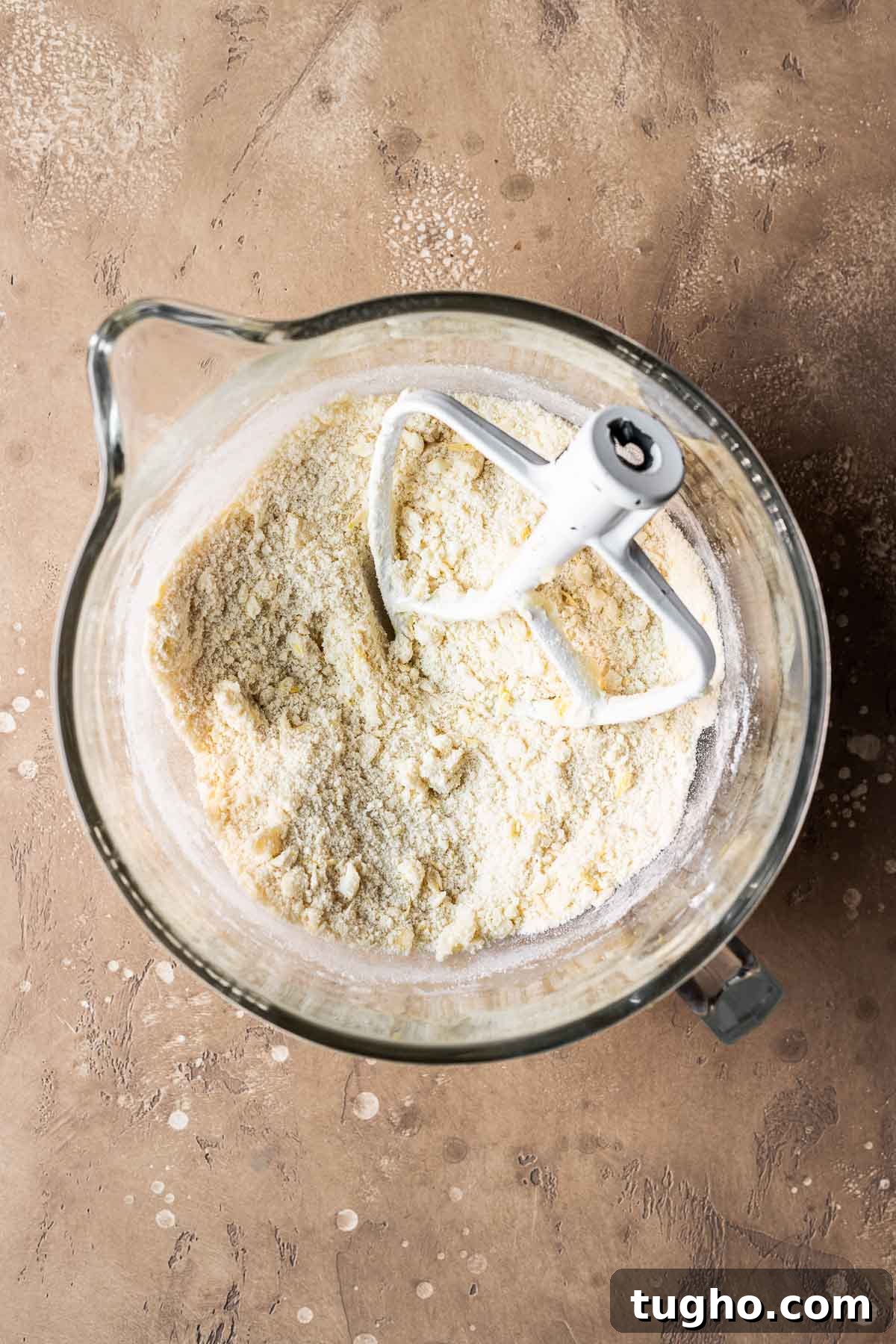Classic Italian Jam Crostata Recipe 5 Dry and wet ingredients for tart dough in a clear glass mixing bowl.