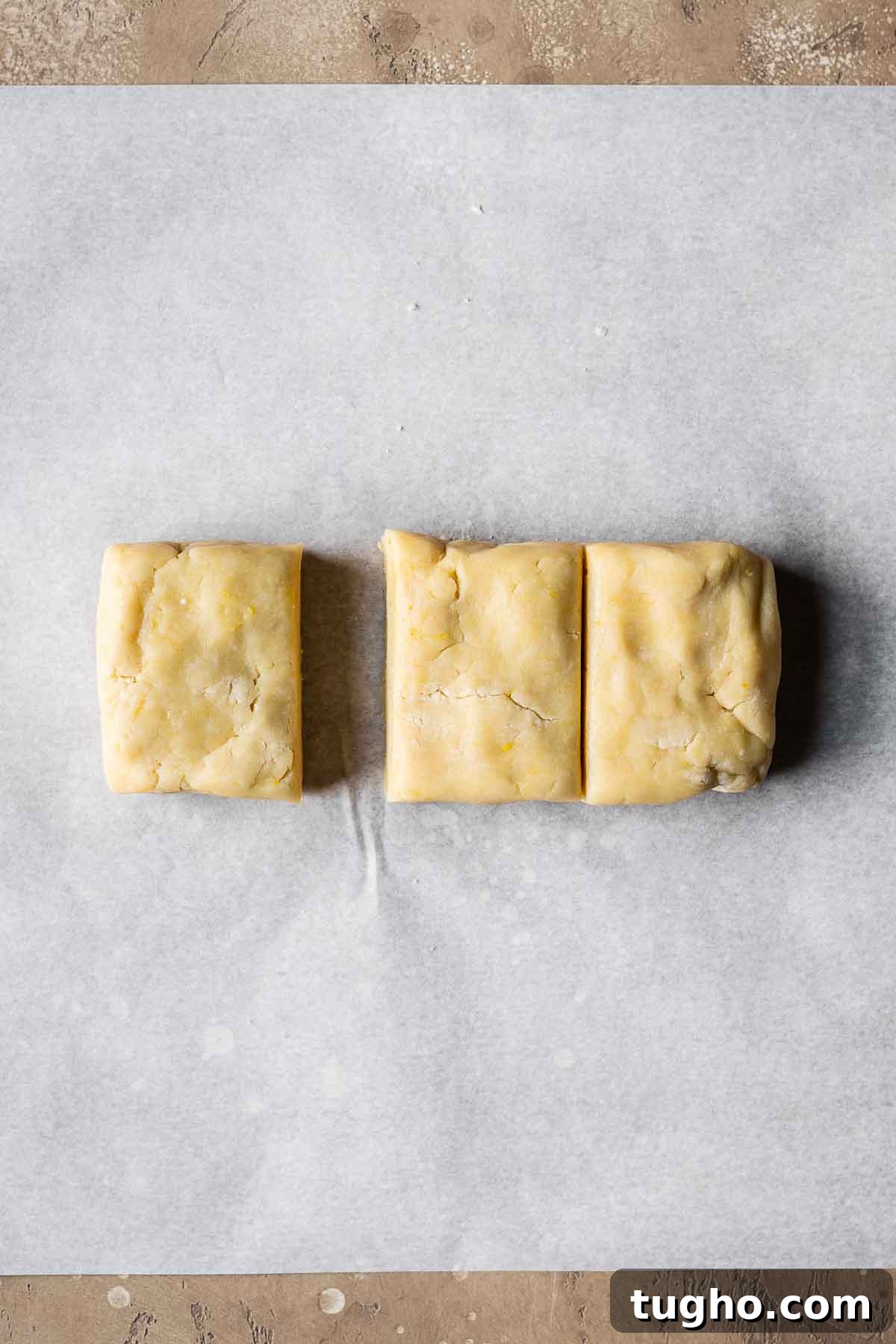 Classic Italian Jam Crostata Recipe 7 Shortcrust pastry dough divided into thirds on parchment paper.