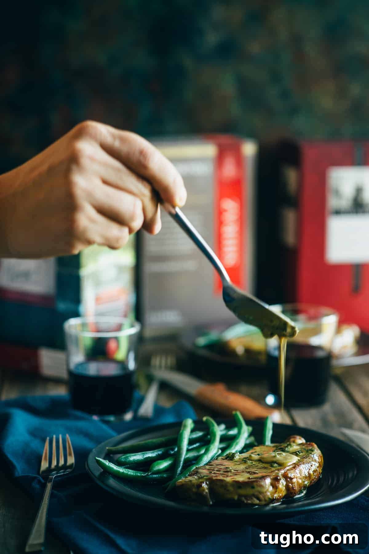 Diane sauce being ladled over a cooked steak