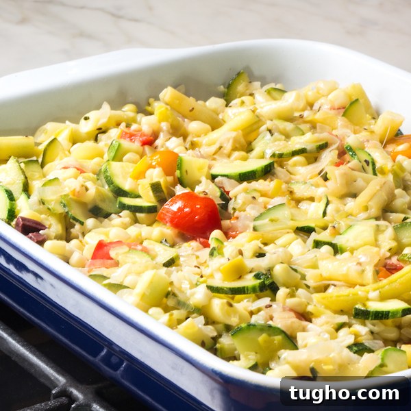 Zucchini Cobbler with Golden Cornbread Topping Recipe 3 Sautéed zucchini, corn, onion, yellow beans, and tomatoes in a baking dish.