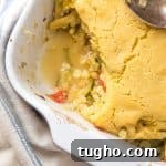 Zucchini Cobbler with Golden Cornbread Topping Recipe 4 Zucchini, corn and bean casserole topped with cornbread, with a scooped out portion.