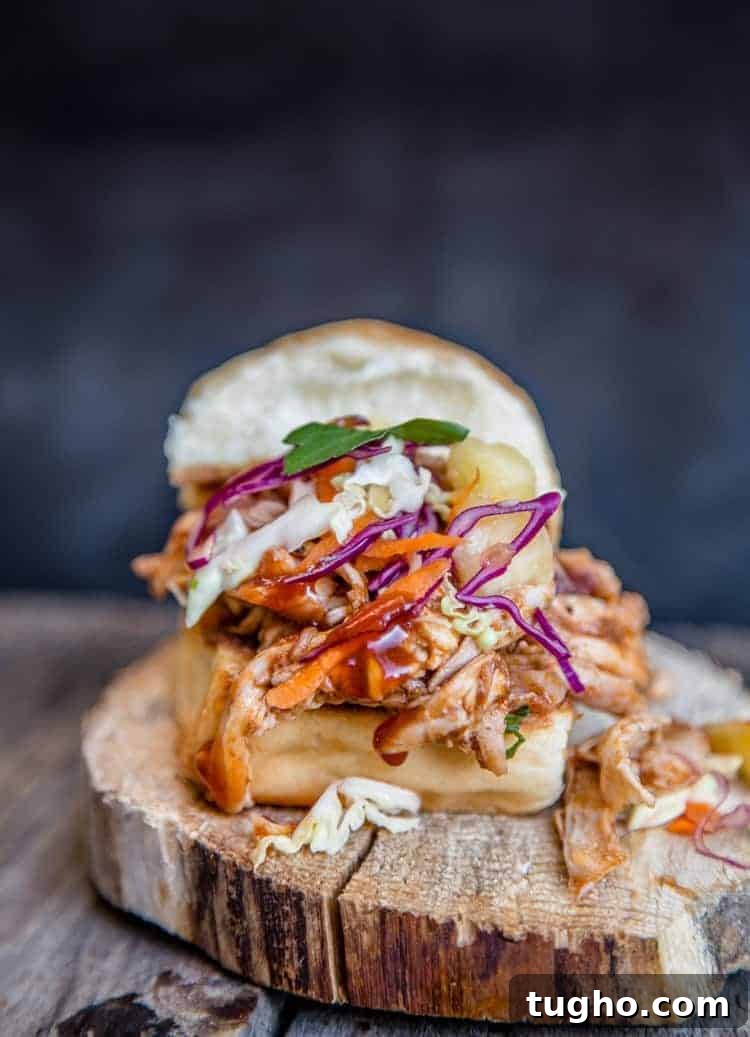A pulled BBQ chicken slider using a Hawaiian style bun