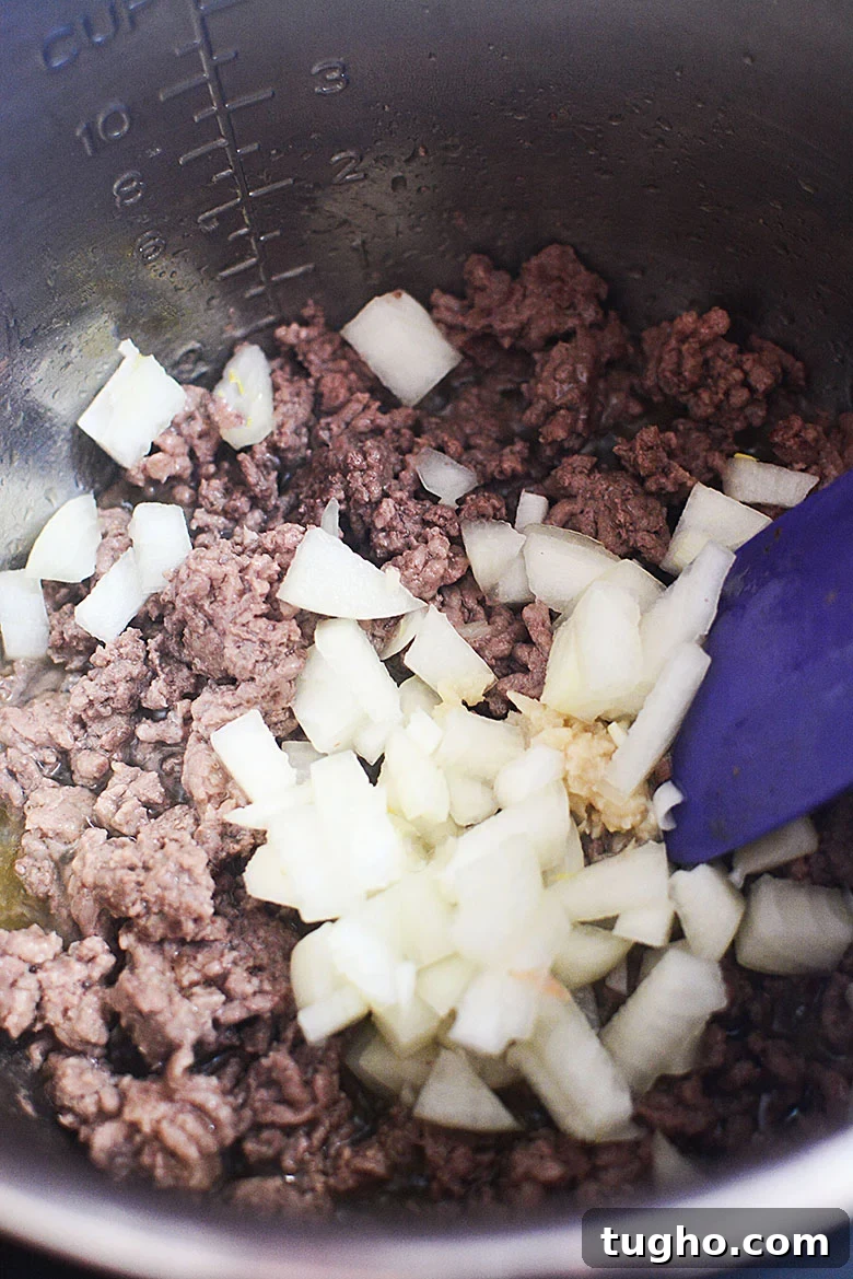 Instant Pot Stuffed Pepper Soup Recipe 5 Cooking Ground Beef in Instant Pot with onions