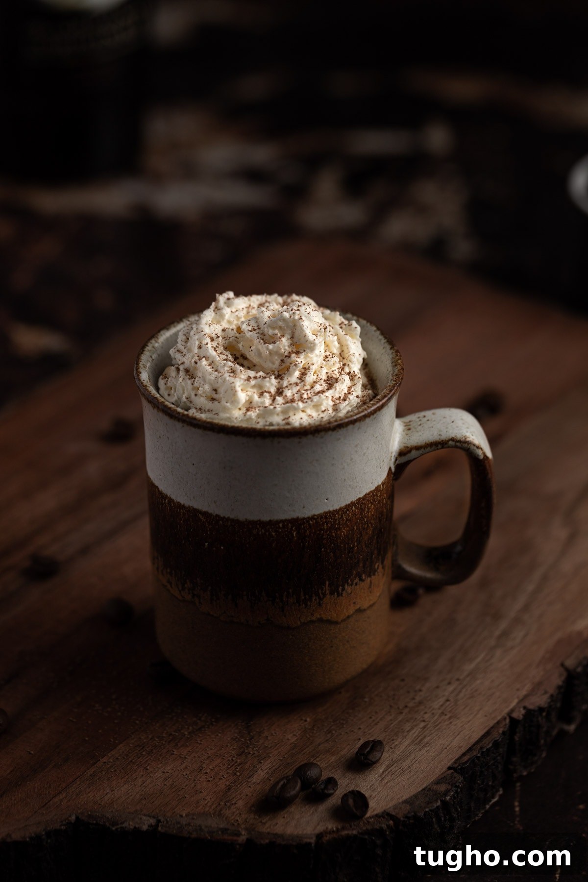 Baileys Iced Coffee Recipe 7 Baileys coffee in a brown mug sitting on a wooden serving board.