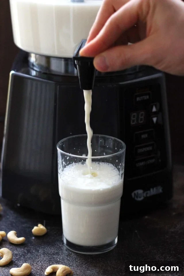 Creamy Vegan Pumpkin Spice Latte Recipe 4 Healthy Vegan Pumpkin Spice Latte - the NutraMilk Dispensing Nut Milk in a Glass Closeup with the Glass Half-Filled