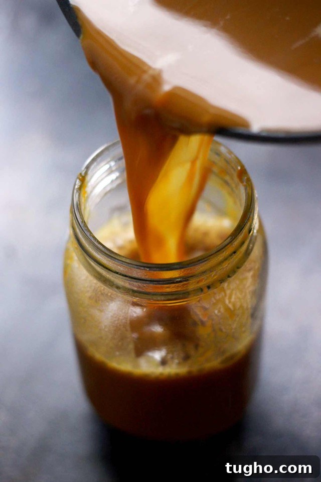 Creamy Vegan Pumpkin Spice Latte Recipe 9 Healthy Vegan Pumpkin Spice Latte Being Poured into a Mason Jar Stnaind on the Table