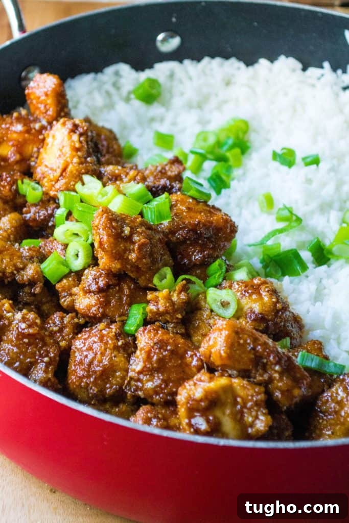 Sticky Sweet and Spicy Chicken Rice Bowls in 30 Minutes 4 Sticky chicken rice bowl with sesame seeds and scallions