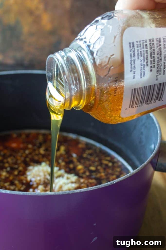 Sticky Sweet and Spicy Chicken Rice Bowls in 30 Minutes 7 Sticky sweet and spicy sauce simmering in a pan