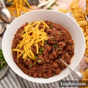 thick Texas style chili with no beans to be served with Fritos and cheese