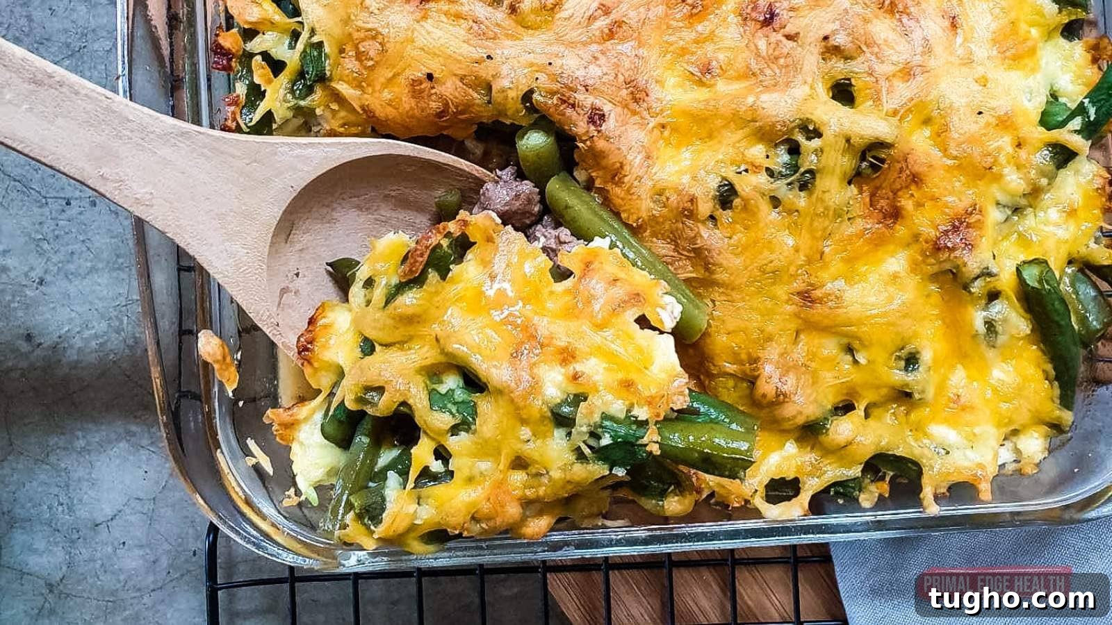 17 No-Fuss Dinners That Make the Whole Family Smile 13 Green bean casserole being served with wooden spoon.