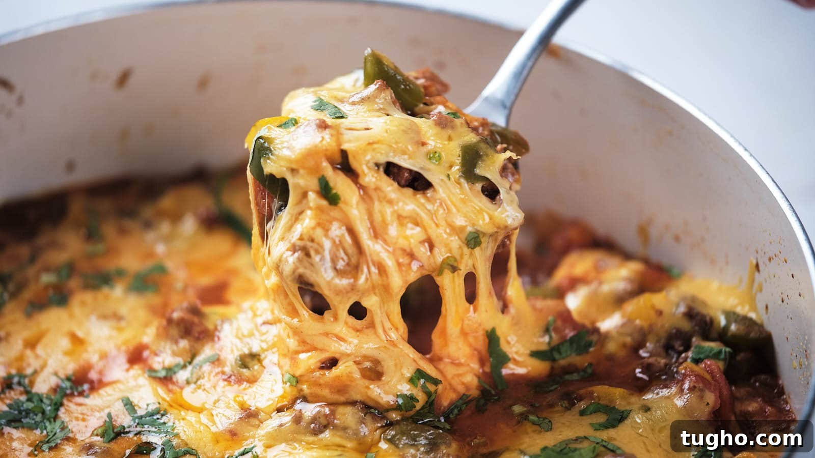 17 No-Fuss Dinners That Make the Whole Family Smile 14 A close-up of ground beef taco skillet being served with a metal spoon.