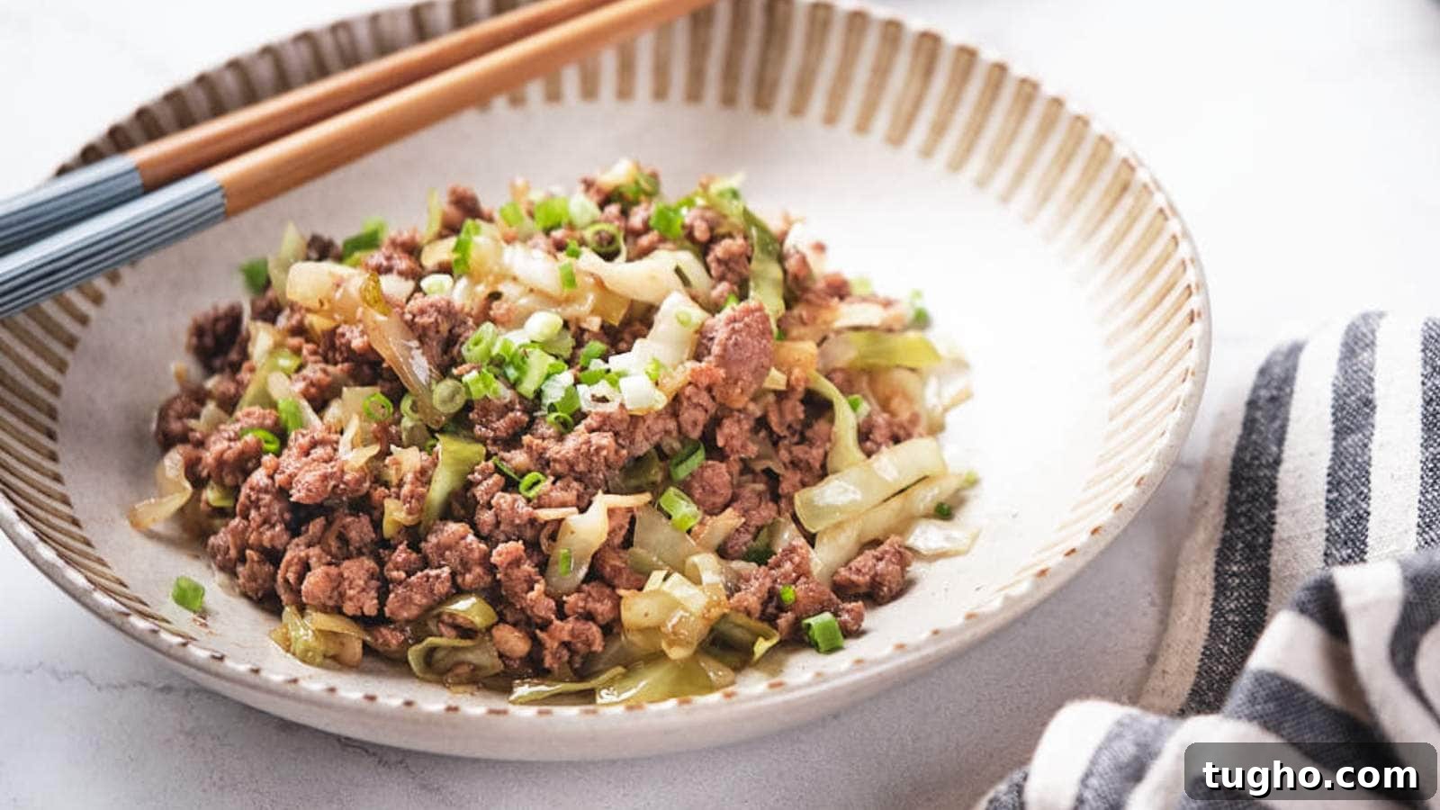 17 No-Fuss Dinners That Make the Whole Family Smile 16 Ground beef and cabbage stir fry being scooped out from a skillet.