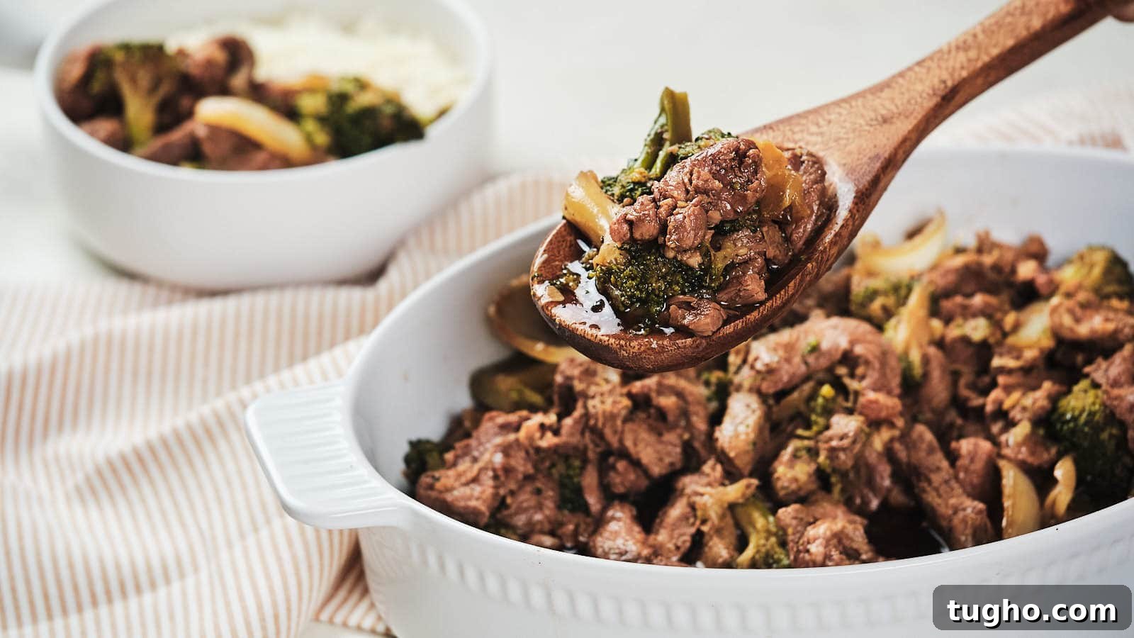 17 No-Fuss Dinners That Make the Whole Family Smile 9 Slow cooker beef and broccoli with onion in brown bowl.