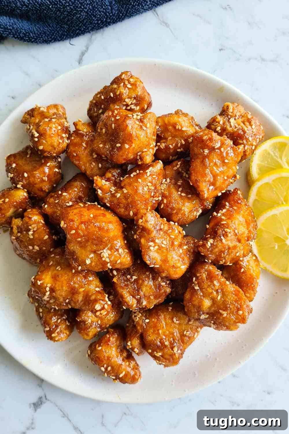 Homemade Crispy Honey Sesame Chicken Recipe 12 An overhead view of a plate of fried chicken pieces