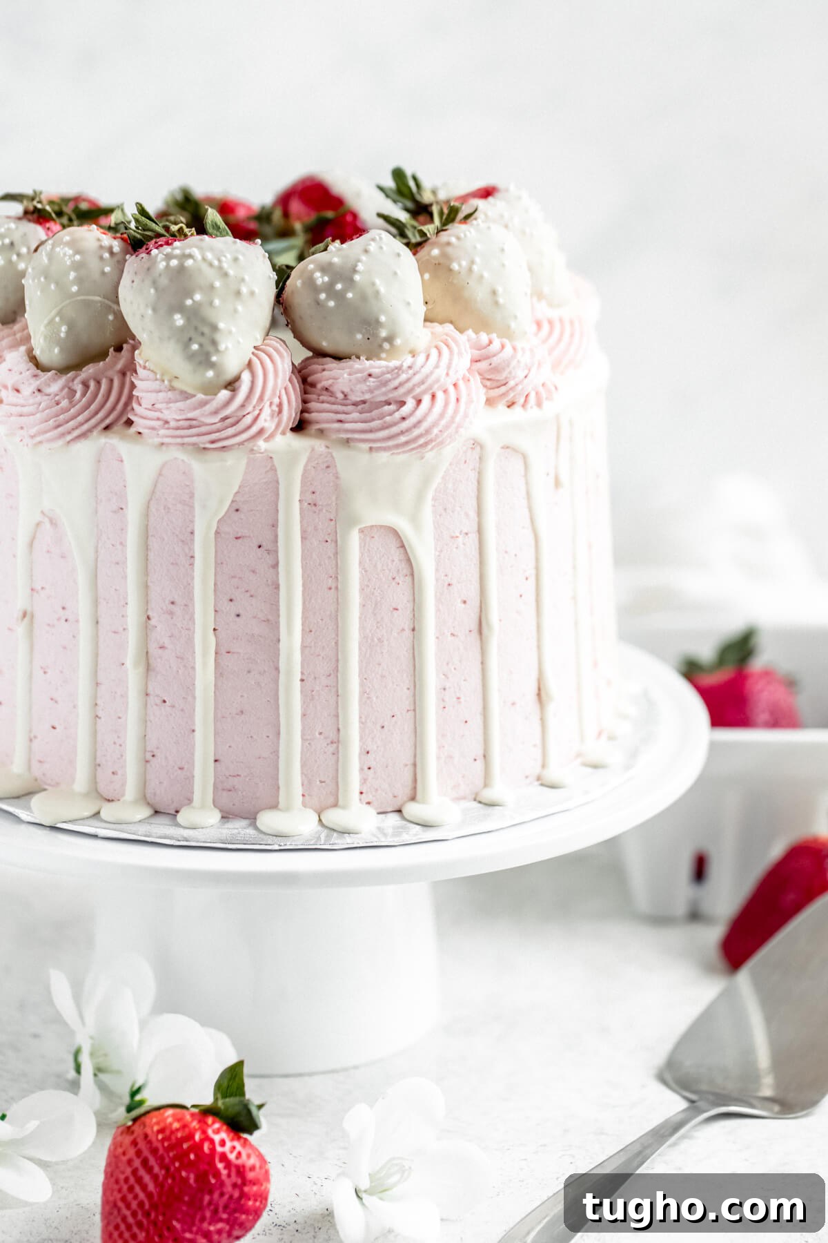 White Chocolate-Covered Strawberry Cake Recipe 2 white chocolate and strawberry cake on a white cake stand