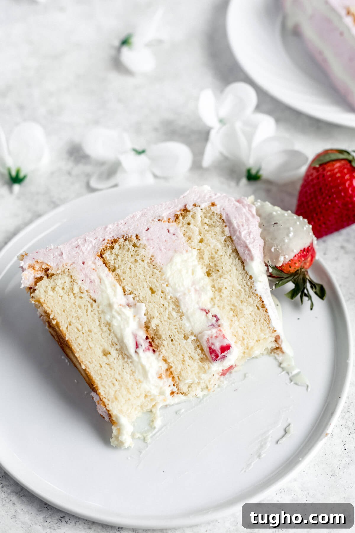 White Chocolate-Covered Strawberry Cake Recipe 5 slice of cake on a white plate