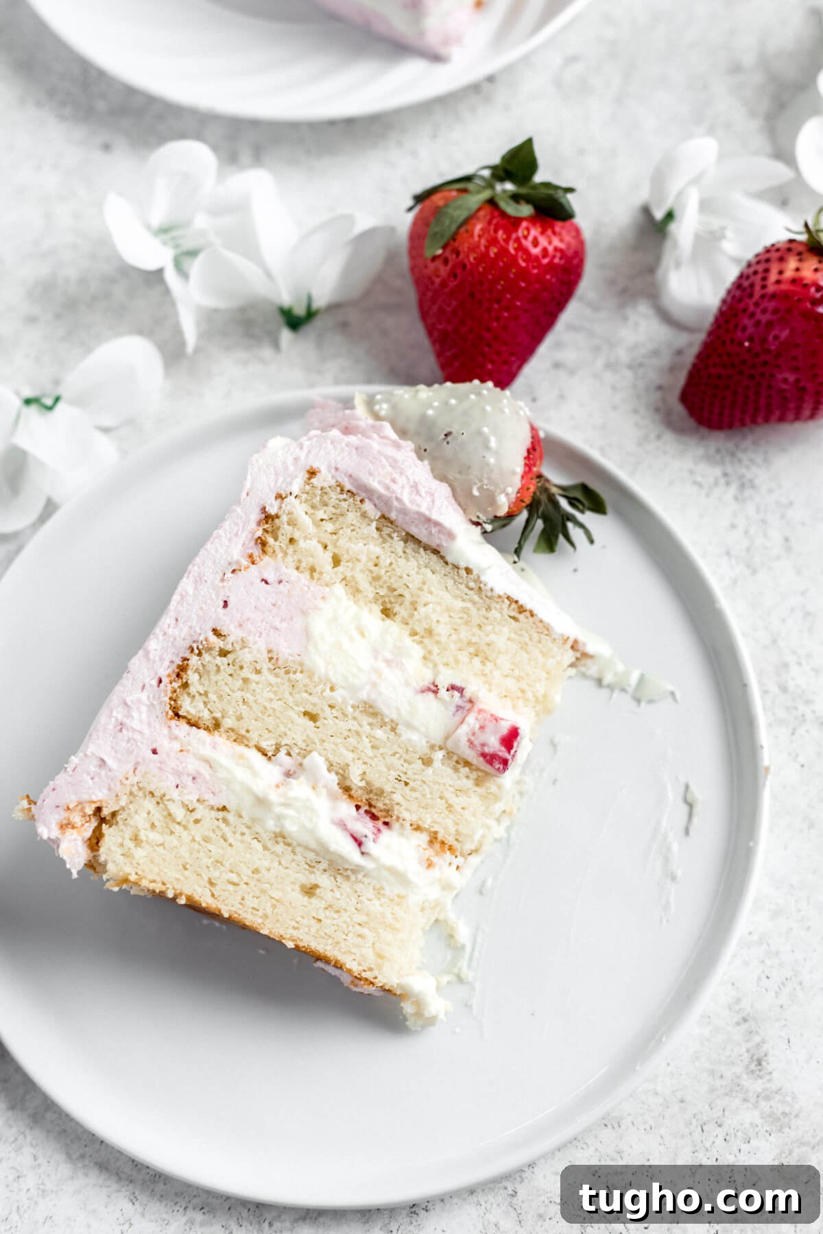White Chocolate-Covered Strawberry Cake Recipe 6 slice of white cake with mousse filling on a white plate with strawberries beside