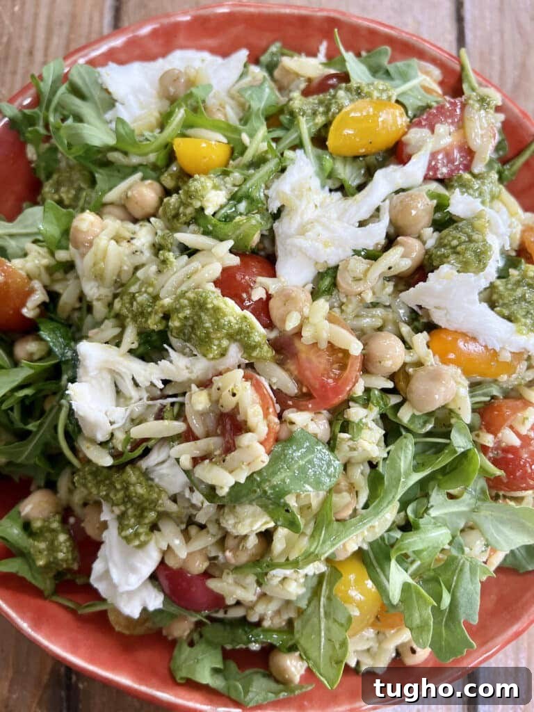 Pesto Orzo Caprese Salad with Cherry Tomatoes and Mozzarella 2 Orzo pesto salad in orange bowl.