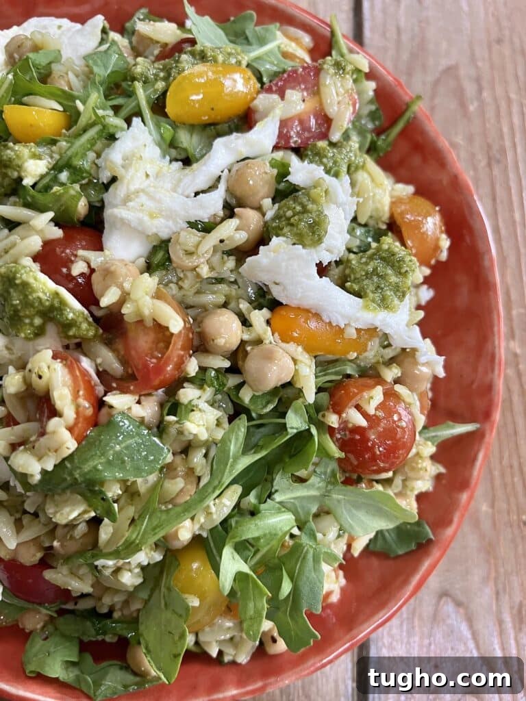 Pesto Orzo Caprese Salad with Cherry Tomatoes and Mozzarella 7 Orzo pasta salad in orange bowl.