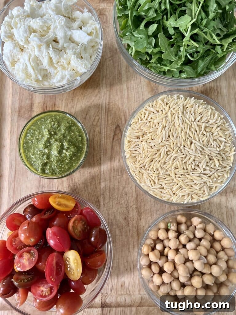 Pesto Orzo Caprese Salad with Cherry Tomatoes and Mozzarella 4 All ingredients to make caprese pasta salad in glass bowls.