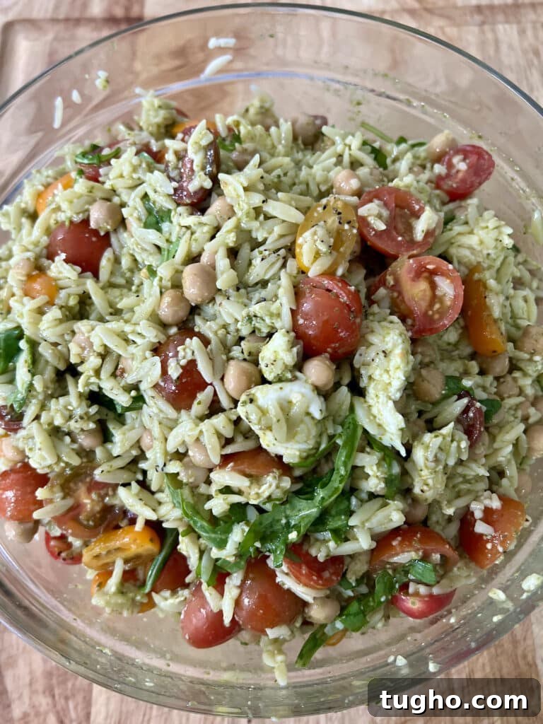 Pesto Orzo Caprese Salad with Cherry Tomatoes and Mozzarella 6 Finished mediterranean orzo pasta salad caprese in glass bowl.