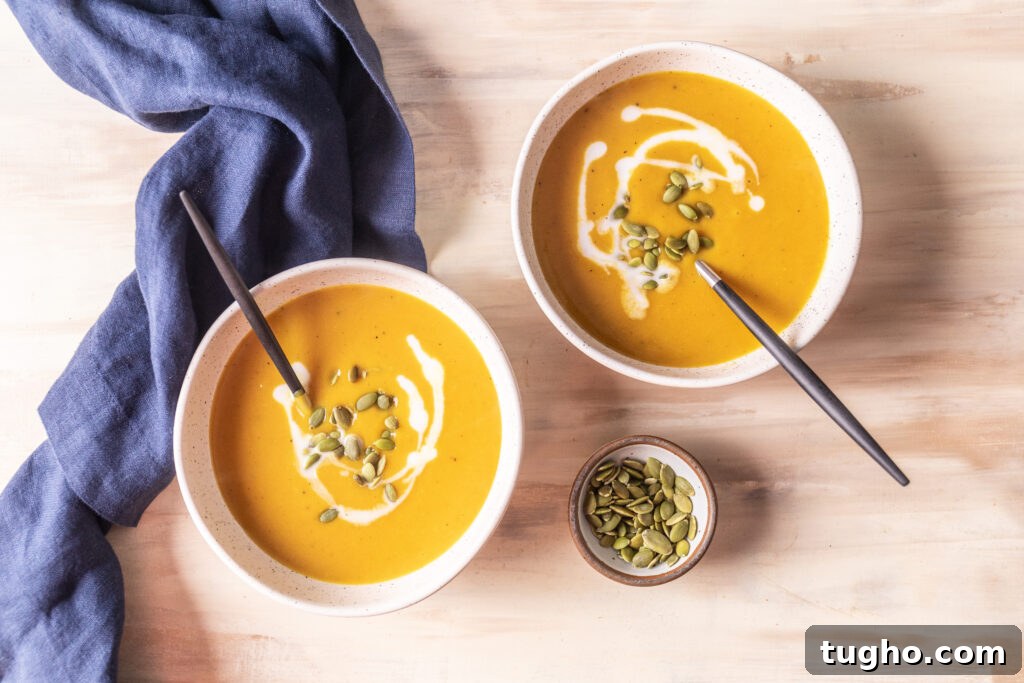 Velvety Roasted Butternut Squash and Carrot Soup Recipe 2 2 bowls of butternut squash and carrot soup topped with pepitas and coconut milk