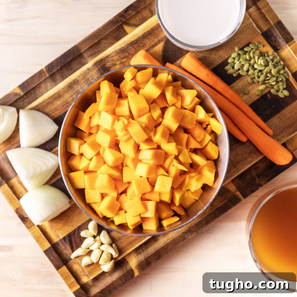 Velvety Roasted Butternut Squash and Carrot Soup Recipe 3 butternut squash and carrot soup ingredients. chopped butternut squash, 3 peeled carrots, coconut milk, chopped onion, fresh garlic cloves, pepitas, and chicken broth