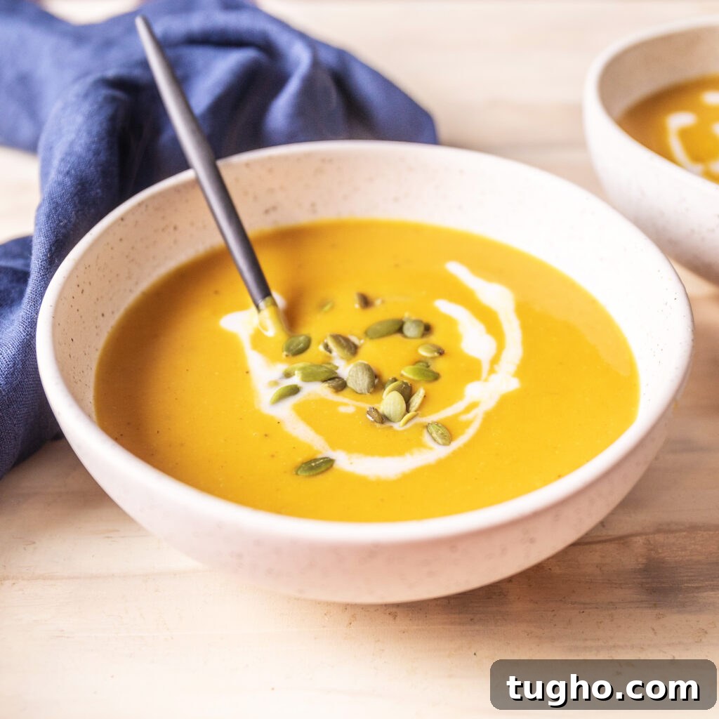 Velvety Roasted Butternut Squash and Carrot Soup Recipe 5 bowl of butternut squash and carrot soup topped with pepitas and coconut milk