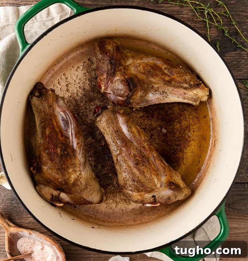 Lamb Shanks Braised in Red Wine 4 lamb shanks browning in dutch oven