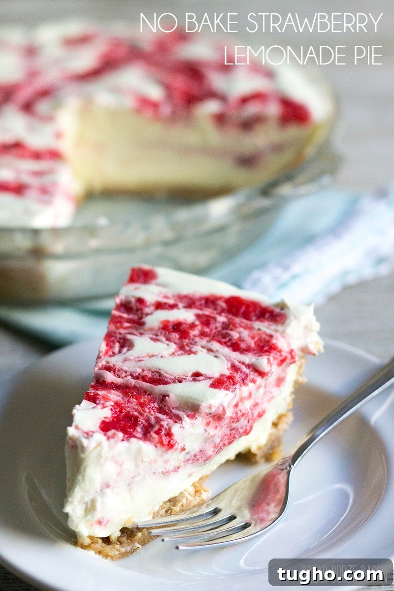 Slice of no bake strawberry lemonade pie on a plate with a fork