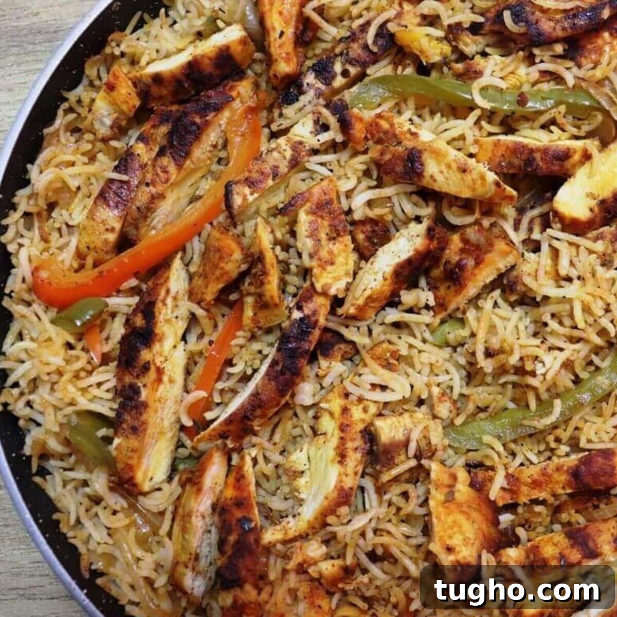 chicken fajita and rice in a skillet.