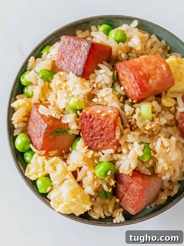 Loco Moco Recipe: Hawaiian Burger with Savory Brown Gravy 13 bowl of spam fried rice with crispy cubes of spam, eggs, green peas, and sesame seeds