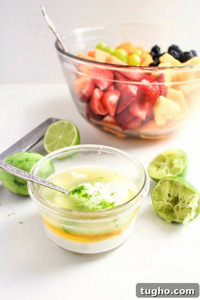 Creamy Honey Lime Greek Yogurt Dressing - 3 Ingredients 4 Greek yogurt with honey and lime in a small glass bowl next to a bowl of fruit