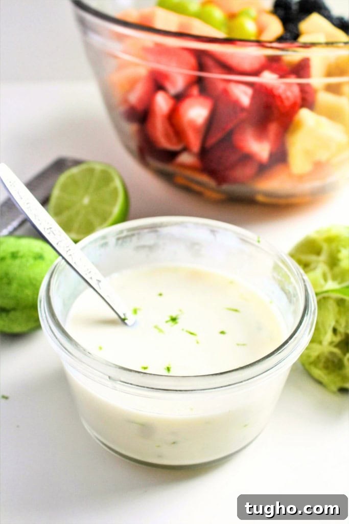 Creamy Honey Lime Greek Yogurt Dressing - 3 Ingredients 5 Greek yogurt lime dressing in a small glass bowl next to a bowl of fruit