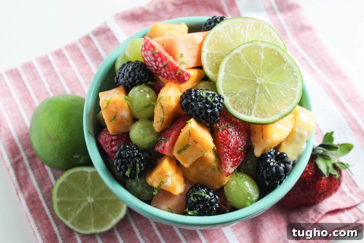 Creamy Honey Lime Greek Yogurt Dressing - 3 Ingredients 6 fruit salad with yogurt dressing and limes in a bowl