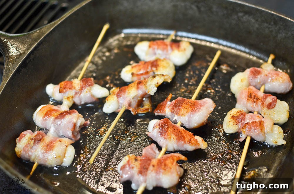Crispy Pan-Fried Bacon-Wrapped Mochi Recipe 6 Bacon wrapped mochi frying in cast iron pan