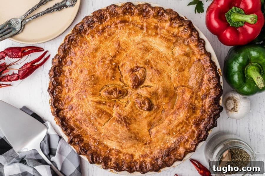 crawfish pie in the middle of the image with bell peppers and cooked crawfish on the outside