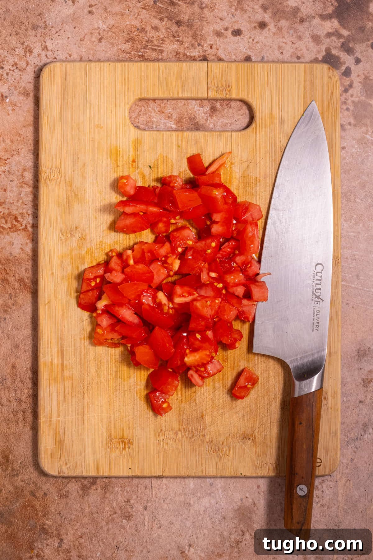 Vegan Lemon Pearl Couscous Salad 5 Diced tomato on a cutting board