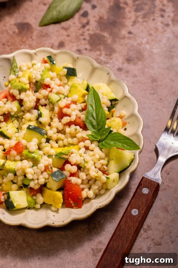 Vegan Lemon Pearl Couscous Salad 9 Close up of vegan couscous salad on a plate